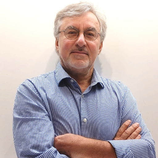 Portrait of Andrei T., a friendly-looking man with glasses and a collared shirt.